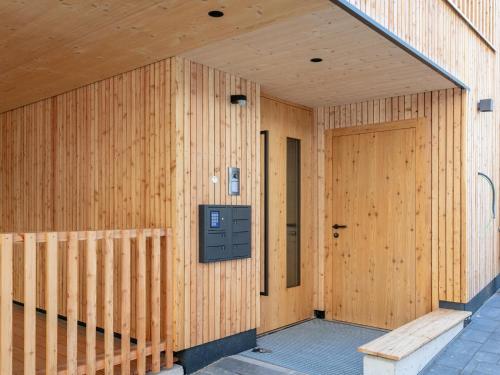 a wooden building with a wooden door on it at Hopfgarten Alpin Living Top 2 in Hopfgarten im Brixental