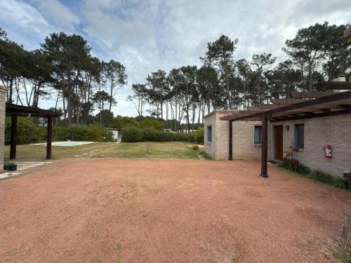 a large dirt yard in front of a building at NEco apartamentos Naturistas Nudistas Parejas o mujeres solas in Punta del Este