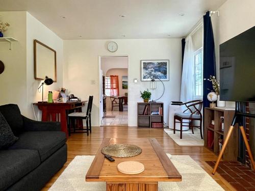 a living room with a couch and a table at Pasadena Quiet Gem with Fiber Internet WiFi and Workspace in Pasadena