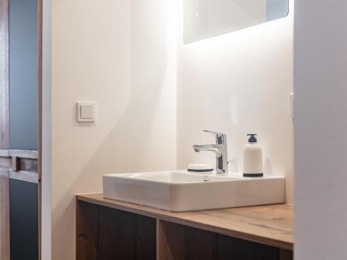 a bathroom sink with a bottle of soap on a counter at Hopfgarten Alpin Living Top 3 in Hopfgarten im Brixental