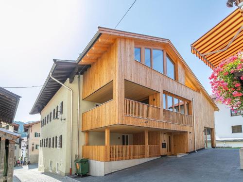 a building with a wooden facade with a balcony at Hopfgarten Alpin Living Top 3 in Hopfgarten im Brixental