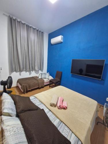 Ένα ή περισσότερα κρεβάτια σε δωμάτιο στο Casarão Maracanã