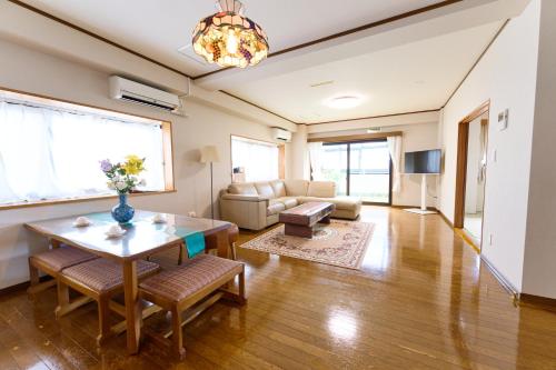 a living room with a table and a couch at Sakura house in Tokyo