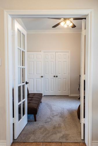 a living room with a couch and a ceiling fan at Keller Haven in Keller