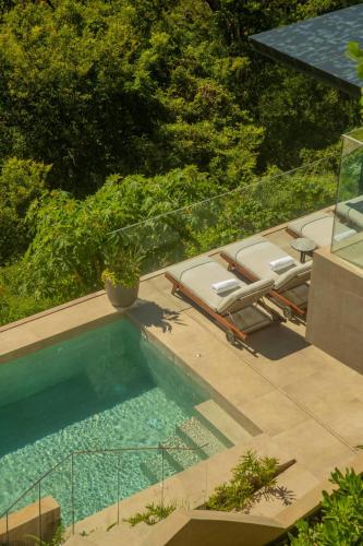 a swimming pool with lounge chairs next to at Villa Coral in Nacascolo