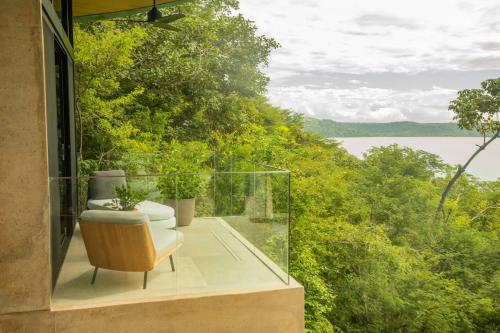 a glass house with a view of the water at Villa Coral in Nacascolo