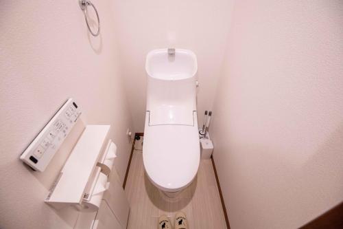a bathroom with a white toilet in a stall at Sand Beige 7mins yokosukachuo station 2-4pax in Yokosuka