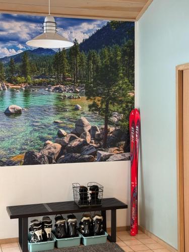 a wall with a painting of a mountain lake at Fully Renovated Northstar Lake Tahoe Retreat in Truckee