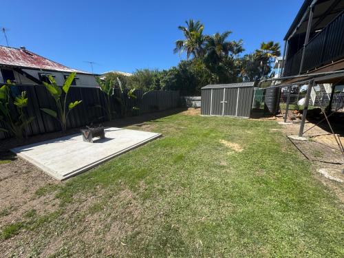 a cat sitting on a ramp in a yard at Panacea Rising in Yeppoon