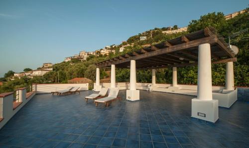 a pavilion with chairs and tables on a roof at Magico Appartamenti Scafa - Marina Capo d'Orlando in Capo dʼOrlando