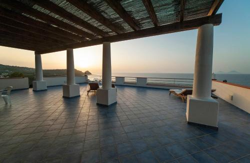 a balcony with chairs and a view of the ocean at Magico Appartamenti Scafa - Marina Capo d'Orlando in Capo dʼOrlando