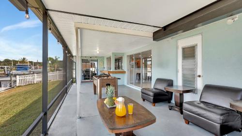 a living room with a table and chairs on a balcony at Gorgeous and Peaceful House by the Water in Port Richey