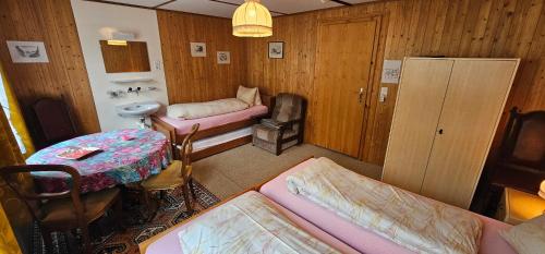 a small room with a table and a sink at Alphenrose saxeten in Saxeten