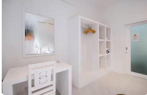 a white room with a table and a window at Steps to Canggu Beach Six Bedrooms, Five Baths in Denpasar