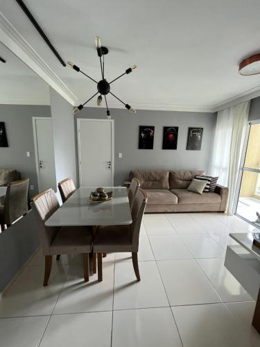 a living room with a table and a couch at Apartamento próximo a Orla de Atalaia in Aracaju
