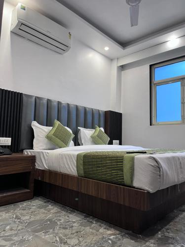 a bedroom with a large bed with a leather headboard at Haveliya Homes- Just 1 minute from Railway Station and Connaught place in New Delhi