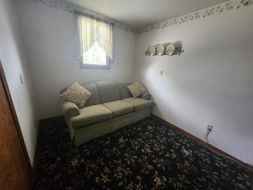 a living room with a couch and a window at The White Birch Inn in Berwick
