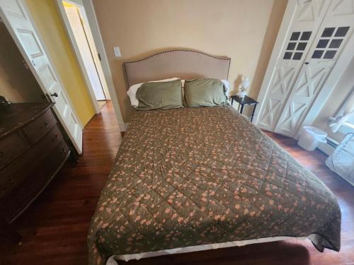 a bedroom with a bed and two white doors at The White Birch Inn in Berwick