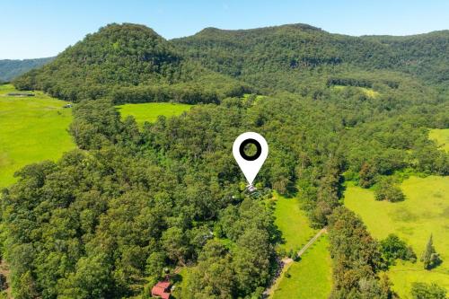 an object is flying in the air over a forest at Wombat Wallows in Kangaroo Valley