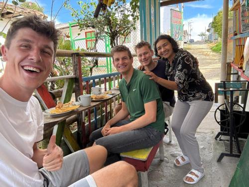 a group of people sitting at a table at Un Café en el camino Guest house in Salento
