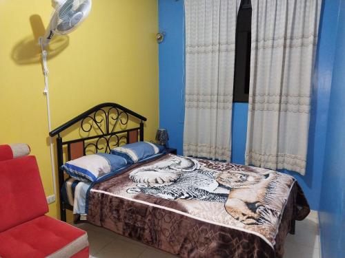 a bedroom with a bed with tigers on it at Departamento Económico # 12 in Moyobamba