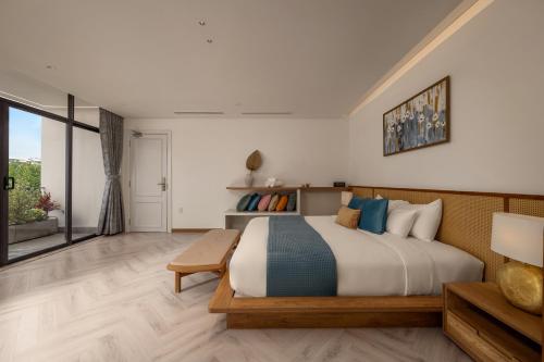 a bedroom with a large bed and a large window at Sora Villa, 4BDR, Large Pool & Elevator Access in Da Nang
