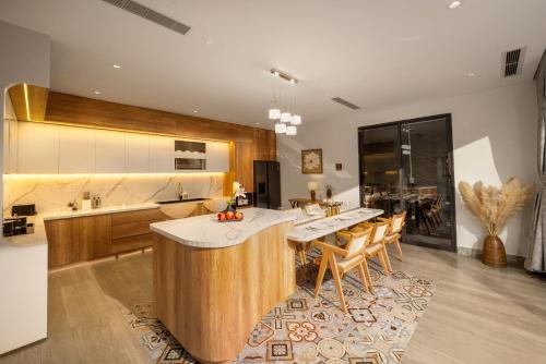 a kitchen with a large island in the middle at Sora Villa, 4BDR, Large Pool & Elevator Access in Da Nang