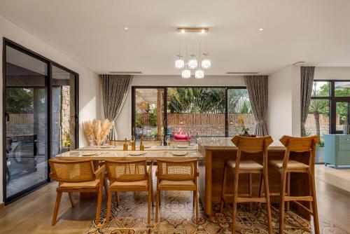 a dining room with a table and chairs at Sora Villa, 4BDR, Large Pool & Elevator Access in Da Nang