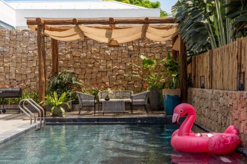 a swimming pool with a pink flamingo in the water at Sora Villa, 4BDR, Large Pool & Elevator Access in Da Nang