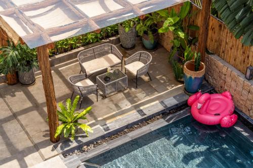 an overhead view of a backyard with a pool and a table and chairs at Sora Villa, 4BDR, Large Pool & Elevator Access in Da Nang