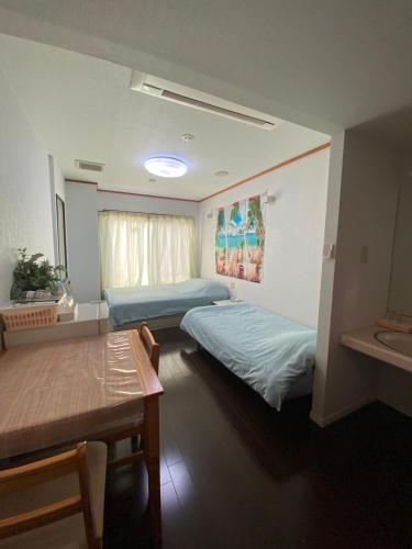 Postel nebo postele na pokoji v ubytování MR. TOMO KAWANA