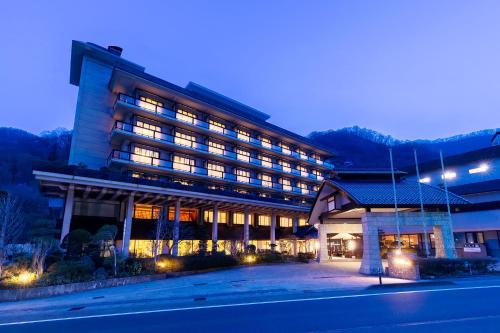 a large building with lights on in the night at Ooedo Onsen Monogatari Premium SendaiSakunami in Sendai