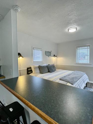 a bedroom with a bed and a table in front of it at Cozy Studio Cottage in Downtown Twin Falls in Twin Falls