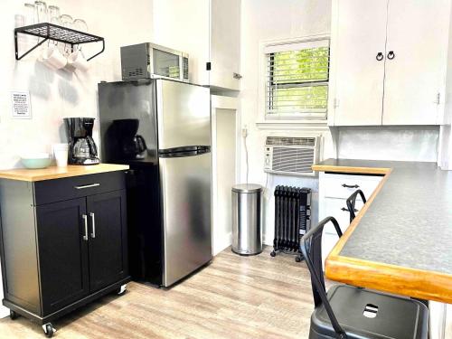 a kitchen with a stainless steel refrigerator and a counter at Cozy Studio Cottage - Downtown Twin Falls in Twin Falls