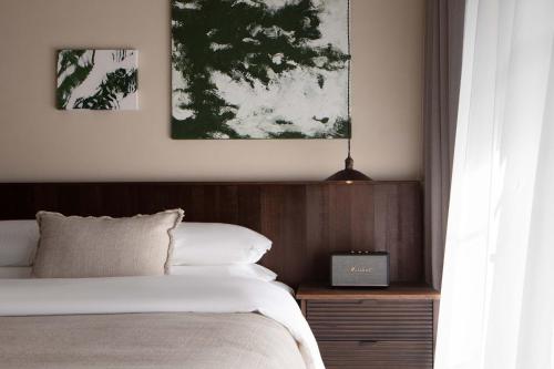 a bedroom with a bed with a wooden head board at Seven Letters · Zhanyue Hotel in Xijiang