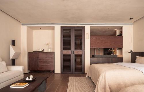 a bedroom with a bed and a couch at Seven Letters · Zhanyue Hotel in Xijiang