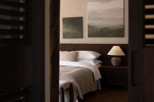 a bedroom with a bed with two paintings on the wall at Seven Letters · Zhanyue Hotel in Xijiang
