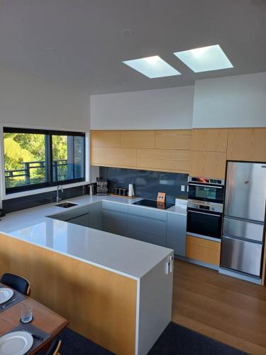 a large kitchen with a large island in the middle at Moetapu Scenic Retreat in Linkwater