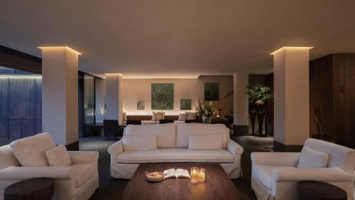 a living room with two white couches and a table at Seven Letters · Zhanyue Hotel in Xijiang