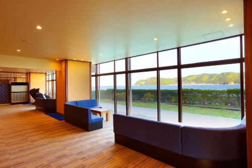a lobby with a large window with a view at Ooedo Onsen Monogatari Nanki Kushimoto in Kushimoto