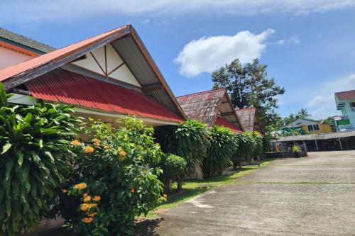 a house with a red roof and some bushes at My Pumpkin Bungalow Krabi in Krabi
