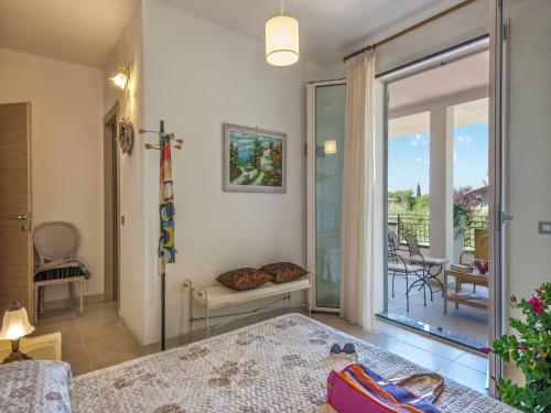 a bedroom with a bed and a balcony at Spacious Villa with Pool in Tavullia