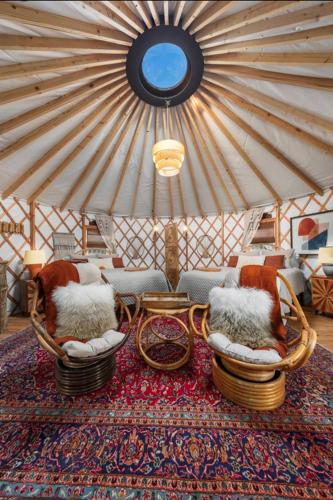 a room with chairs and a rug on a table at Boho Bliss Yurt - Unit # 4 in Woodway