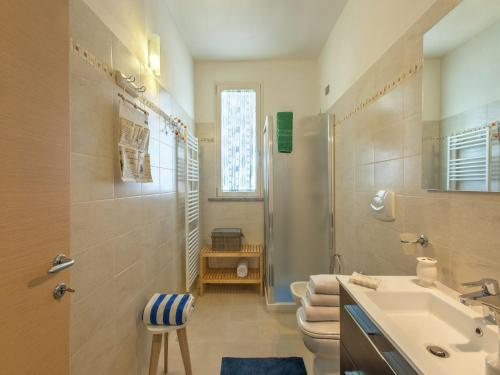 a bathroom with a sink and a toilet and a shower at Spacious Villa with Pool in Tavullia