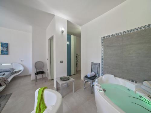 a white bathroom with a tub and a sink at Tranquil Escape in Tavullia in Tavullia