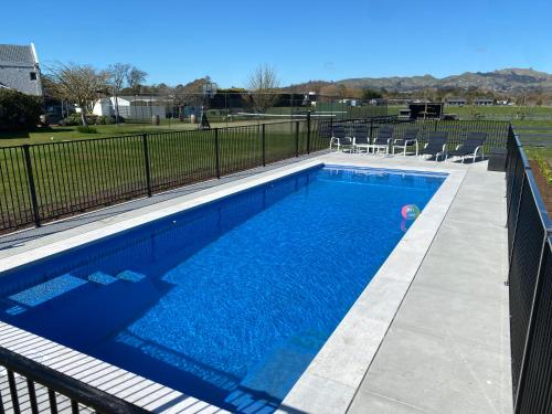 a swimming pool with a person in the water at Lodge On St Georges in Havelock North