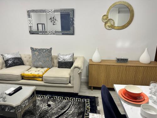 a living room with a couch and a mirror at Mega3 Luxury 2Bedrooms Apartment -2Baths, 2Toilets in Manchester