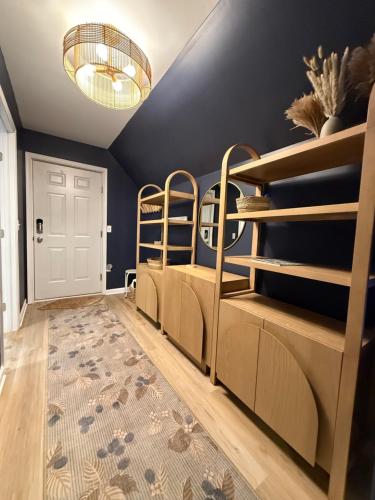 a bedroom with bunk beds and a blue wall at Seaberry Hideaway, A Modern 2BR Apt 3miles to Bethany Beach in Ocean View
