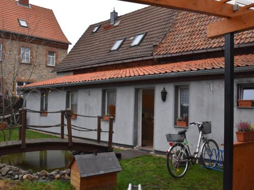 a bike parked next to a house with a bridge at Nature Escape in Meisdorf in Meisdorf
