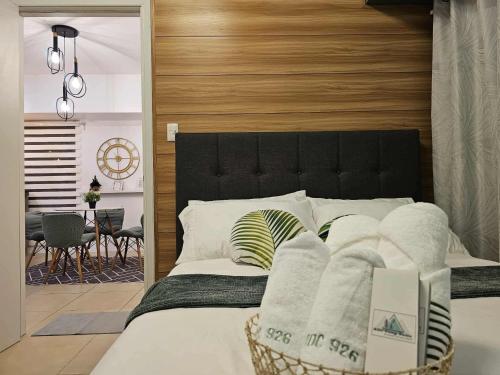 a bedroom with a large bed with a wooden headboard at RDC Cozy Suite in Tagaytay